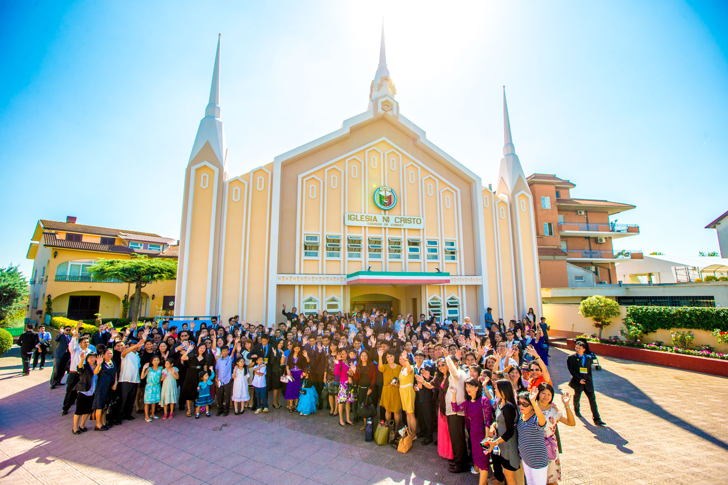 Members of the Iglesia Ni Cristo (Church Of Christ) in Rome, Italy with their house of worship in their background located at Via Viguzzolo 16, Rome, September 2014.