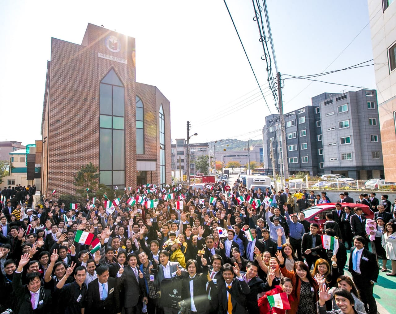 Brethren in South Korea, with Ansan Congregation's worship building at the background.